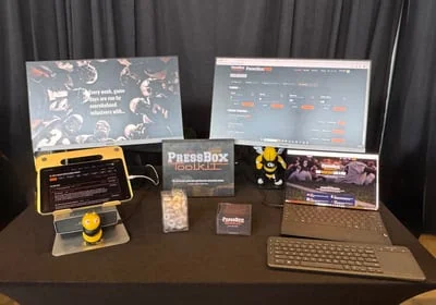 The Press Box Toolkit demo table with laptops and monitors running the app