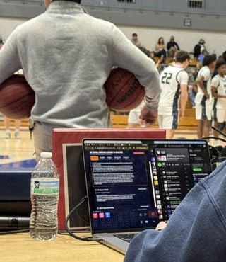 Press Box Toolkit running on a laptop at the scorer's table during a high school basketball game